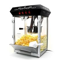 Black and silver tabletop popcorn machine with popcorn in the cabinet