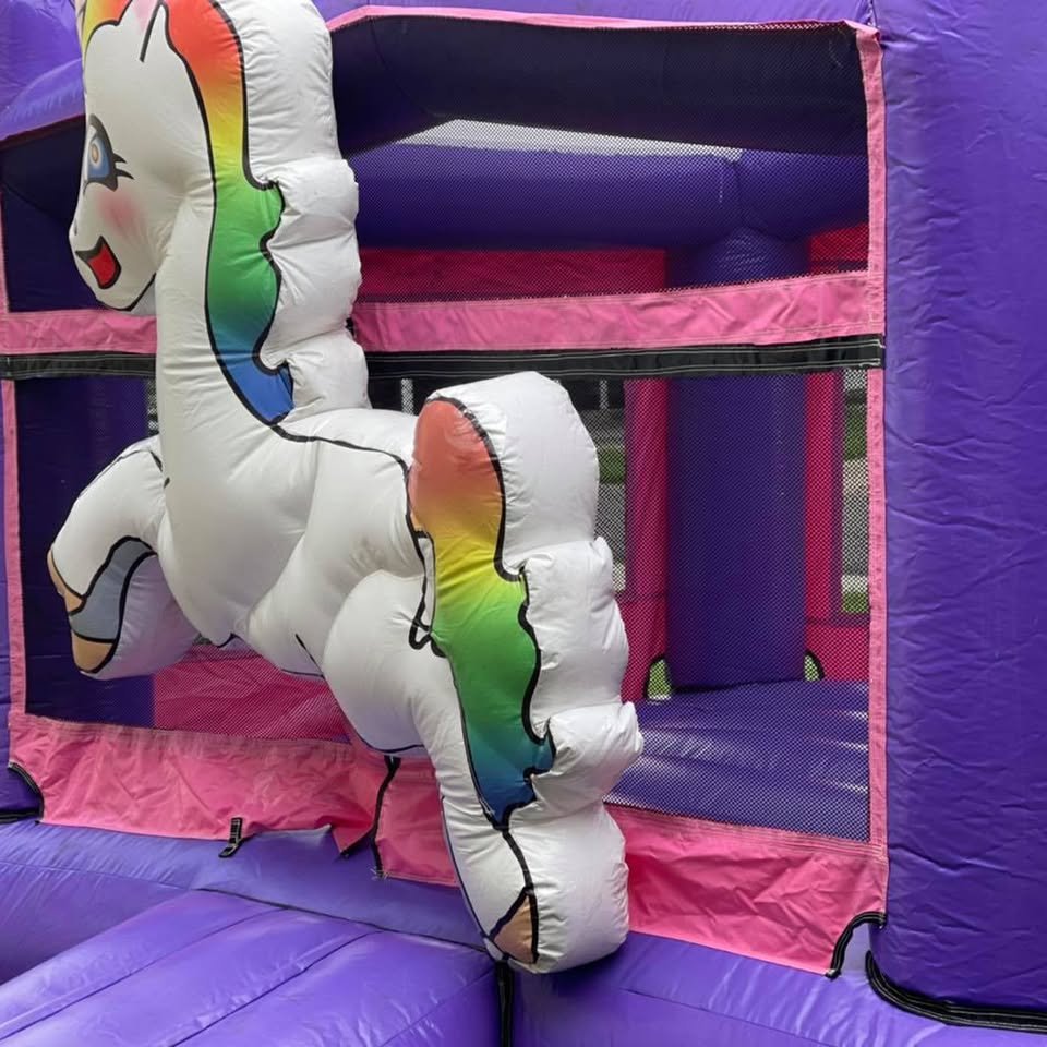 Close-up of the 3D white unicorn with a rainbow mane on the bounce house